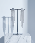 Silver half moon chain fringe drop earrings on marble jewellery stand