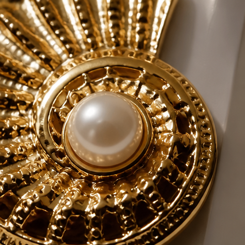 Model wearing gold nautilus shell pearl stud earrings