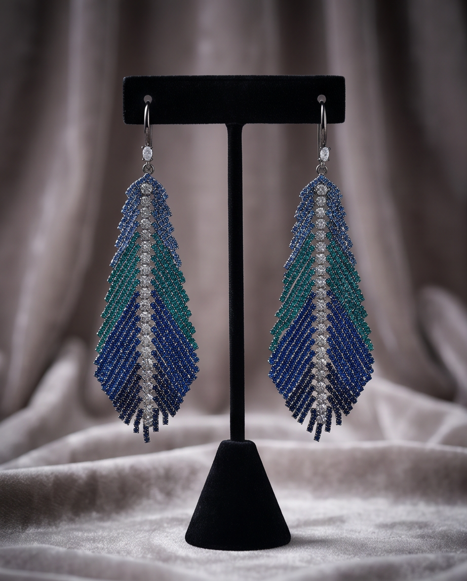 Ocean Ombre Crystal Feather Drop Earrings — flat lay on white satin with gift box