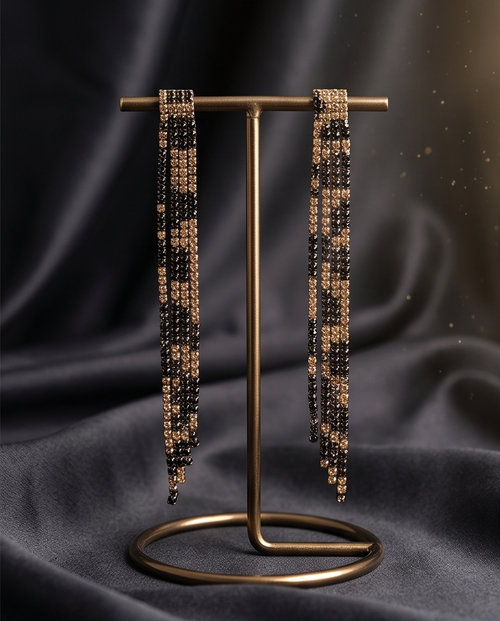 Black and gold crystal fringe drop earrings worn by model at candlelit dinner
