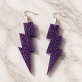 Purple Glitter Lightning Bolt Drop Earrings - lifestyle flat lay with gift box