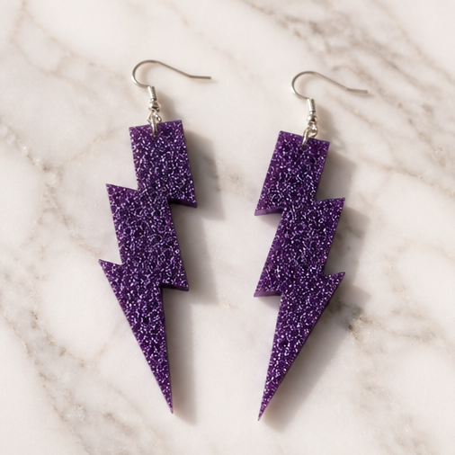 Purple Glitter Lightning Bolt Drop Earrings - lifestyle flat lay with gift box