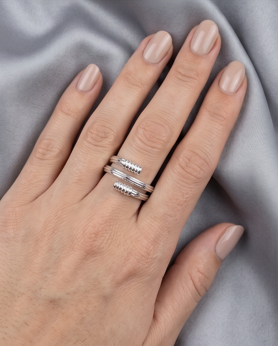 Macro close-up of polished ribbed barrel tips on silver coil wrap ring