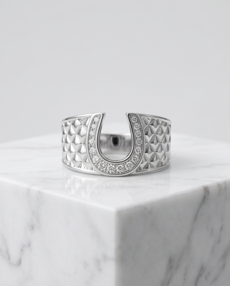 Silver crystal pavé horseshoe quilted ring on marble pedestal