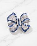 Silver & Blue Sapphire Crystal Bow Brooch on marble background
