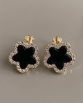 Black enamel clover crystal clip earrings - close-up detail