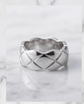 Silver quilted dome ring in grey velvet gift box on marble