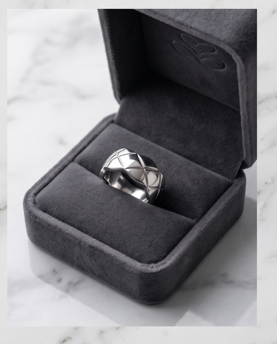 Silver quilted dome ring on marble surface flat lay