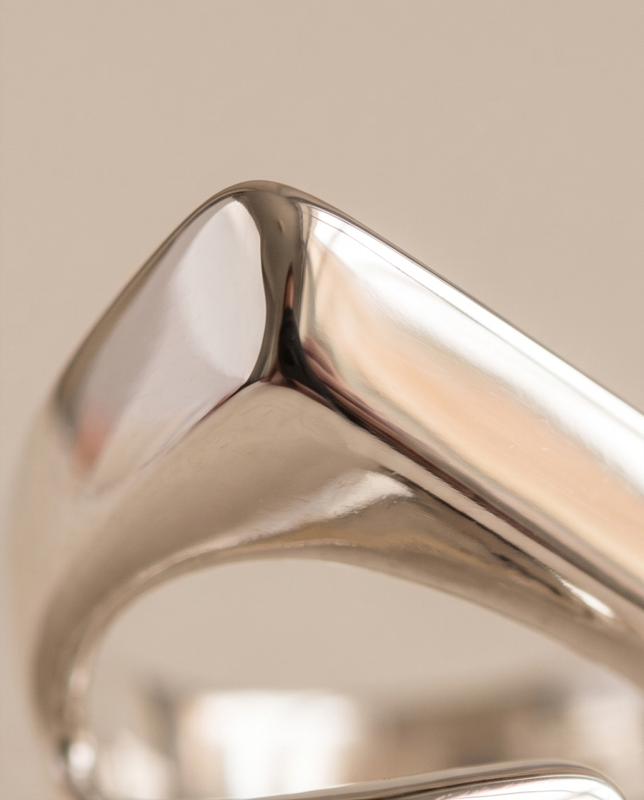 925 silver plated high polish geometric bar and square signet wrap open adjustable ring on concrete plinth showing full architectural wrap silhouette and signet square detail