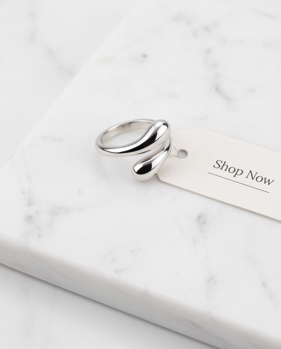 925 silver plated sculptural double teardrop wrap open adjustable ring on white marble with Shop Now gift tag — clean editorial product shot