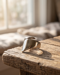 925 silver plated high polish chunky cushion signet open adjustable ring on edge of weathered driftwood in warm window light — slow living editorial