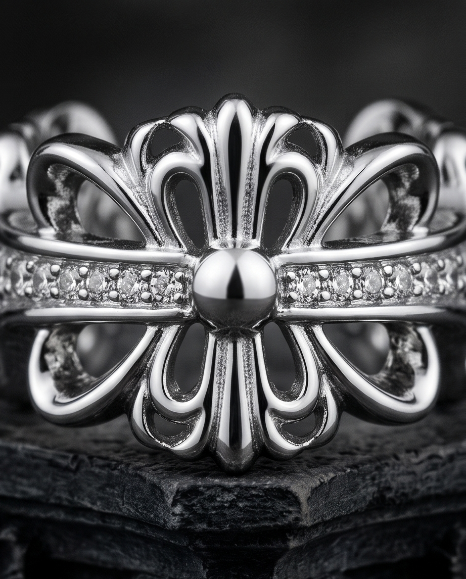 Model's hand resting on gothic stone ledge in front of cathedral arch wearing silver plated gothic fleur de lis baroque cross CZ pave band open adjustable ring — dramatic dark architecture lifestyle editorial