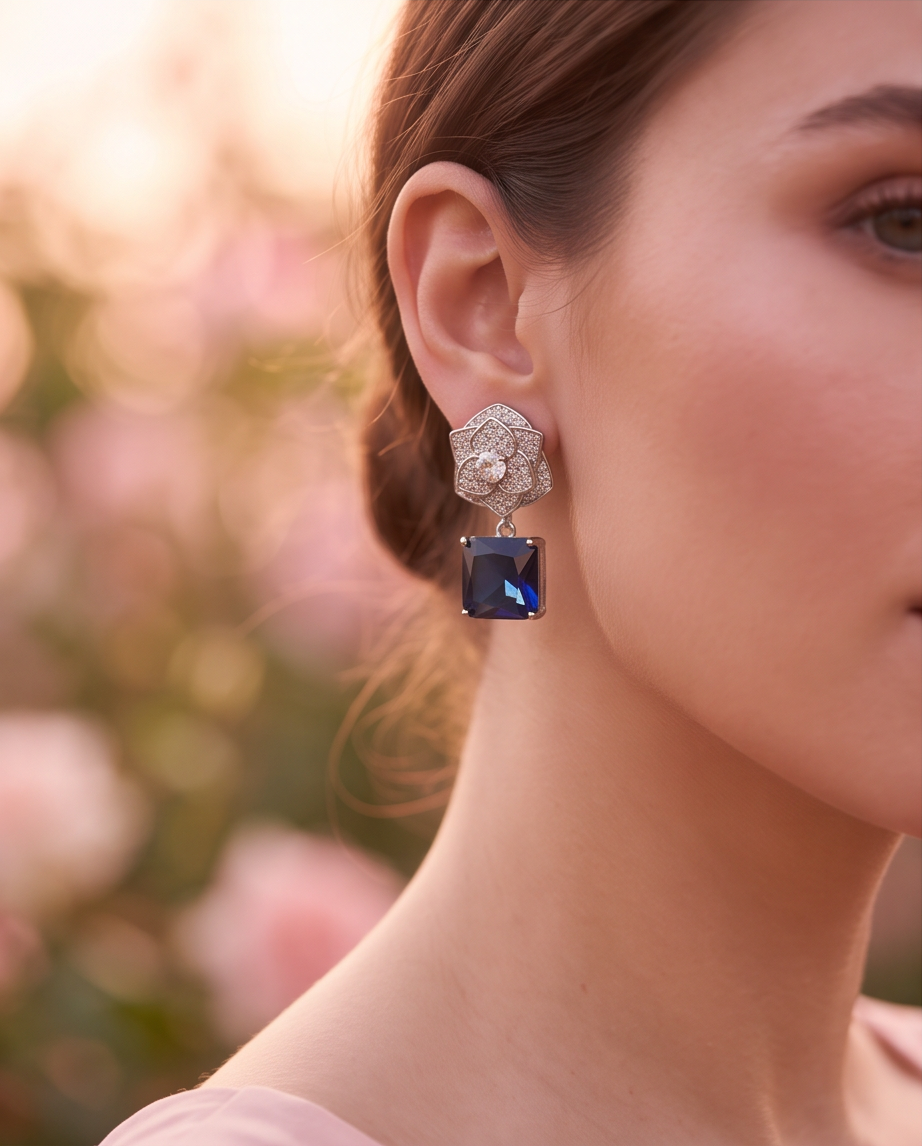 Sapphire Rose Pavé Drop Earrings - styled on model with updo against soft rose garden background