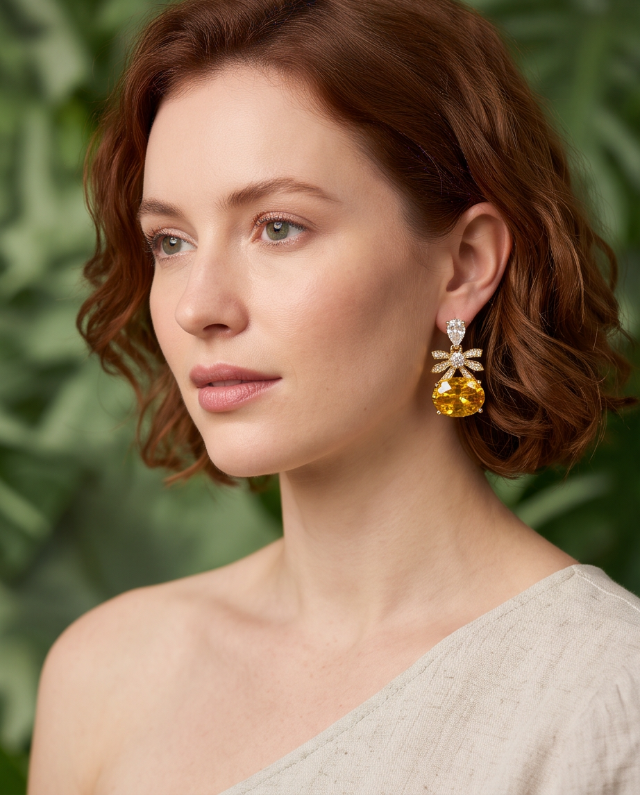 Citrine Bow & Crystal Drop Earrings - side profile model shot showing full earring drop against green foliage