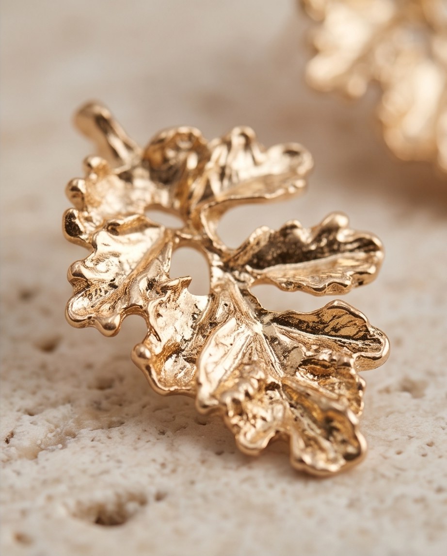 Gold textured oak leaf drop earrings flat lay