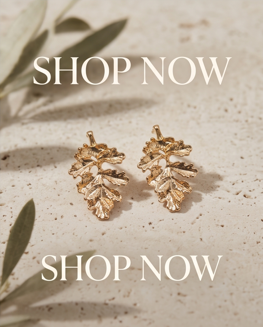 Gold oak leaf drop earring worn on model