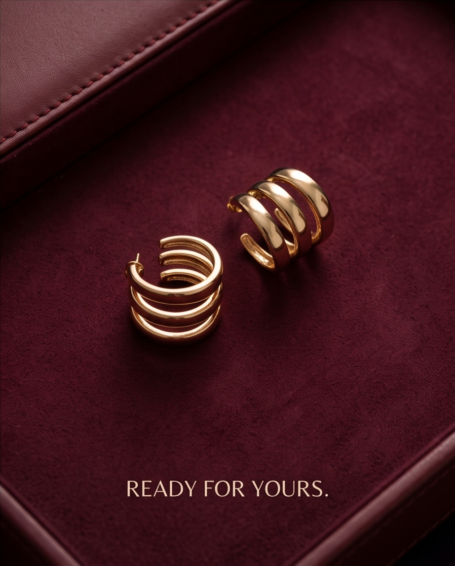 Gold triple band hoop earrings on burgundy velvet jewellery tray