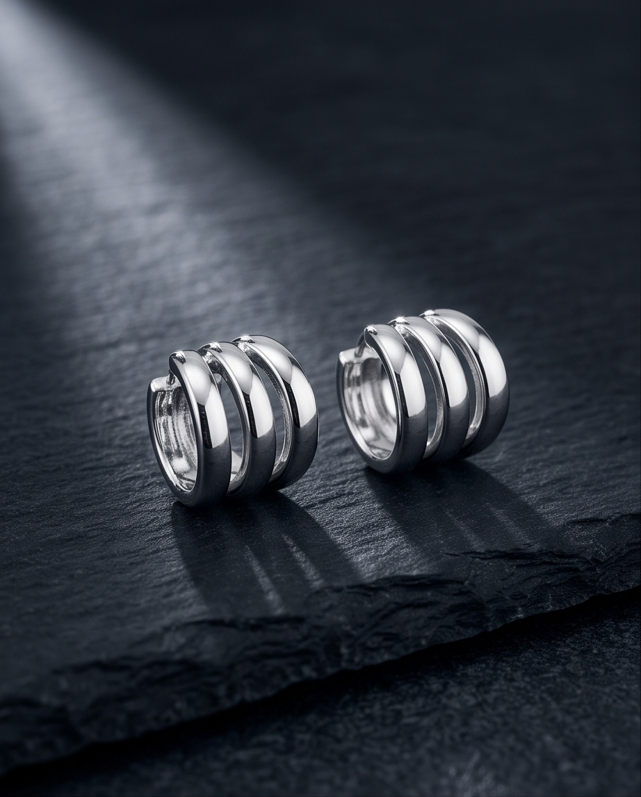 Silver triple band chunky hoop earrings on black slate product shot
