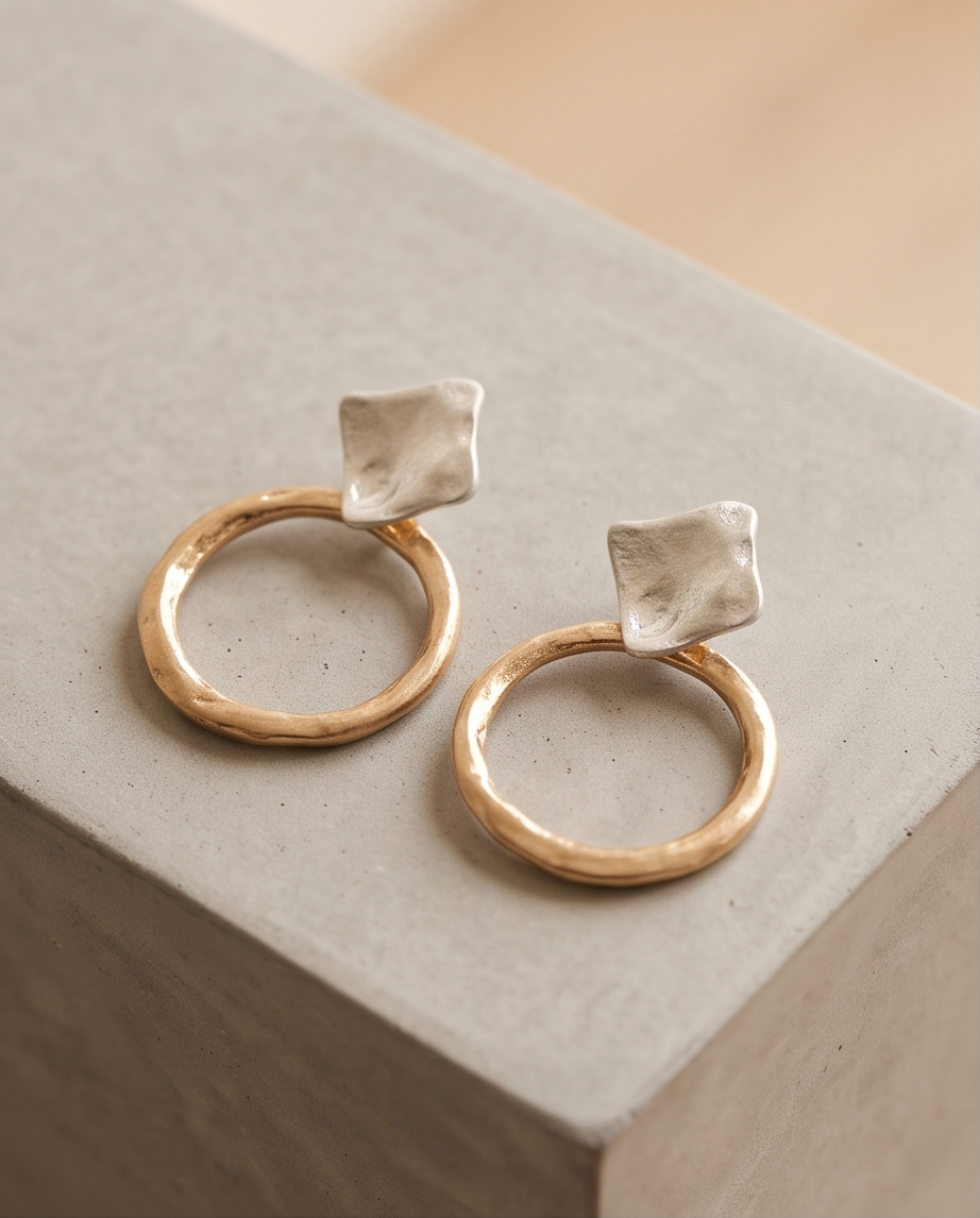 Close-up of the hammered silver square stud and textured gold hoop