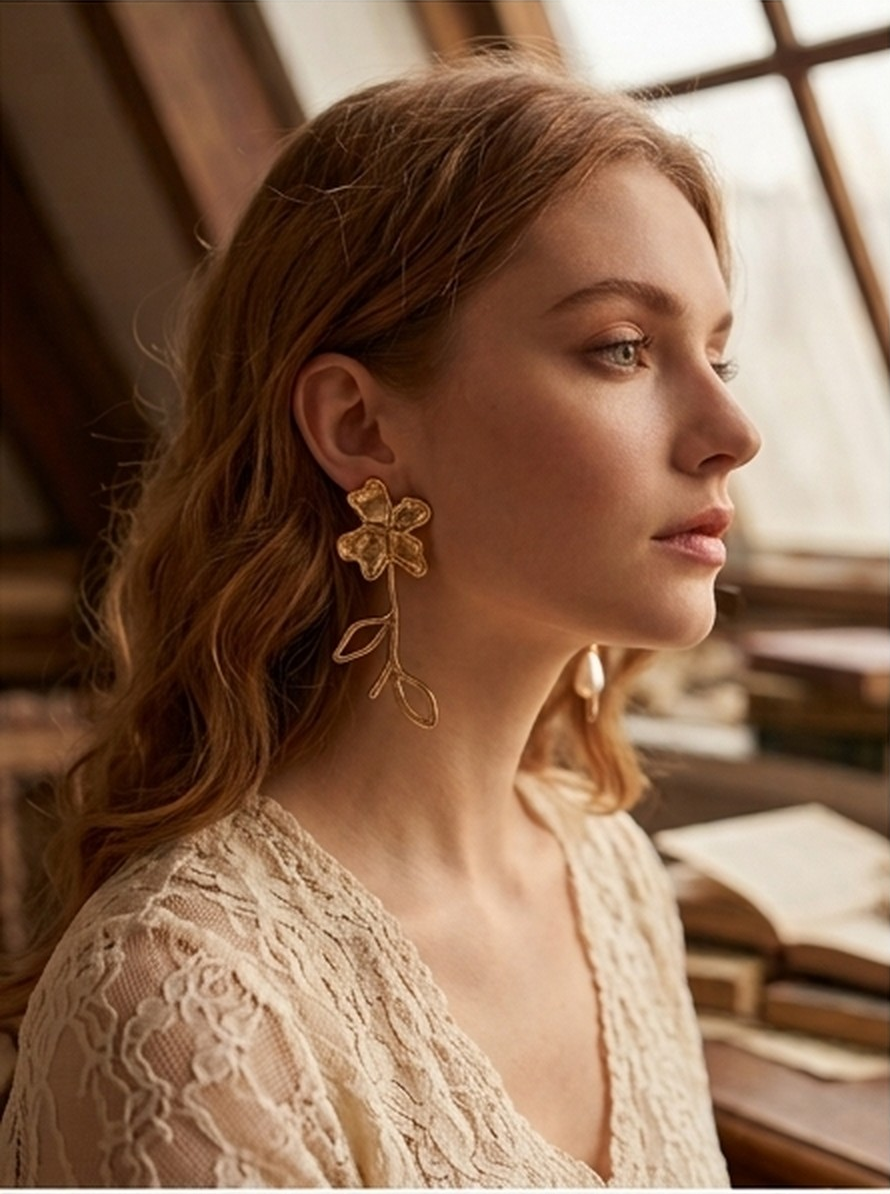 Close-up of the hammered gold flower head and teardrop pearl