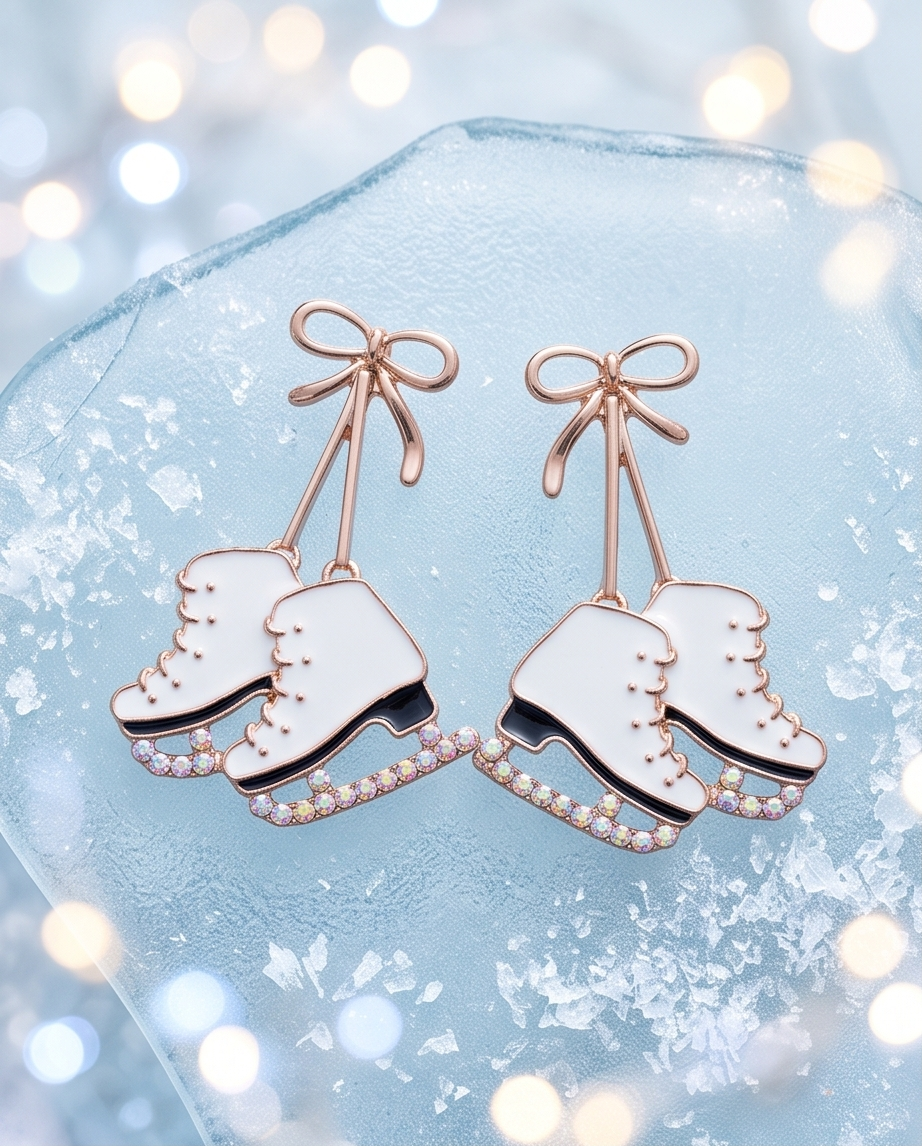 Rose gold bow ice skate drop earrings on snow