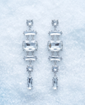 Pair of silver-tone geometric drop earrings with clear faceted crystal-style detailing
