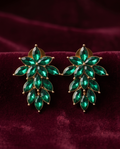 Emerald green floral drop earring worn on ear, showing styling and scale