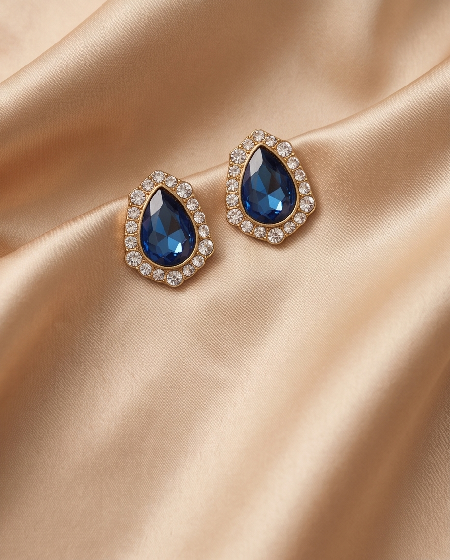 Close-up of blue faceted teardrop and clear-stone halo