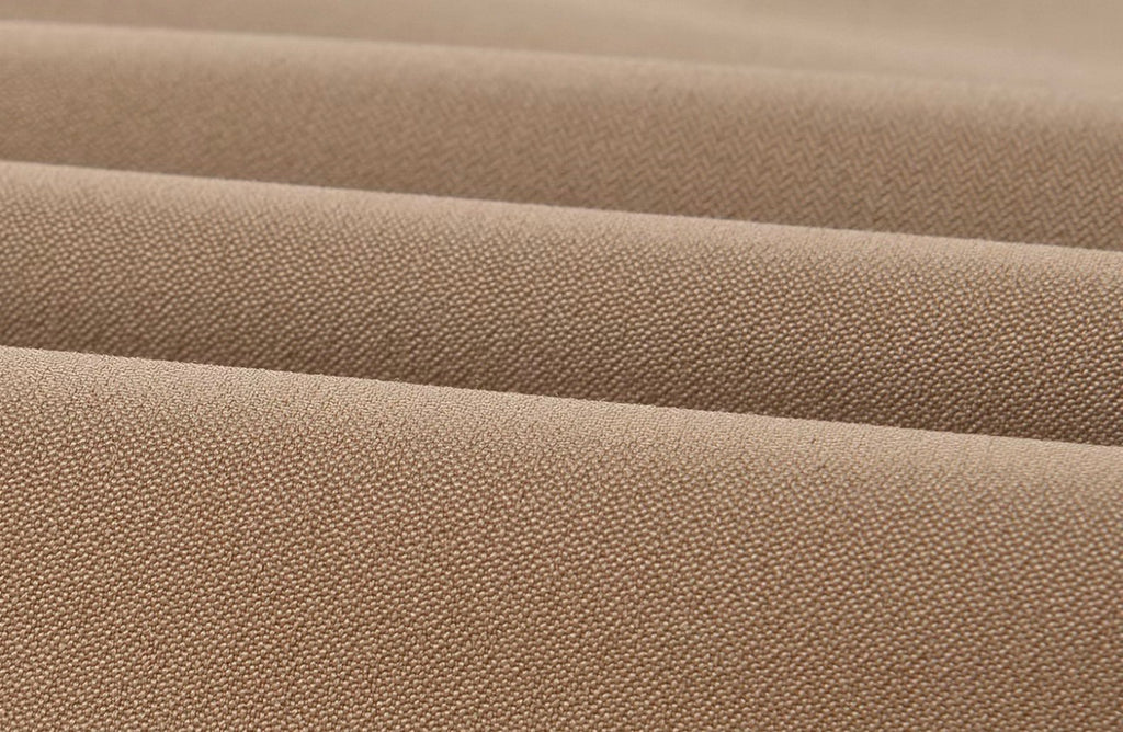 Close-up of a beige woven fabric with a fine textured surface, showing soft horizontal folds.