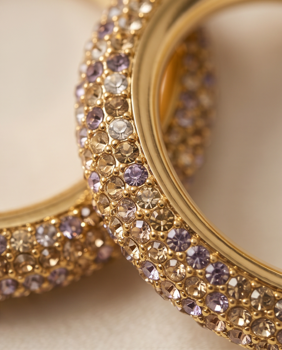 Extreme macro close-up of gold pavé crystal hoop showing champagne and lilac crystal detail