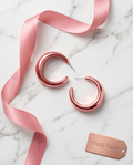 Rose gold chunky hoop earrings on rose gold pedestal