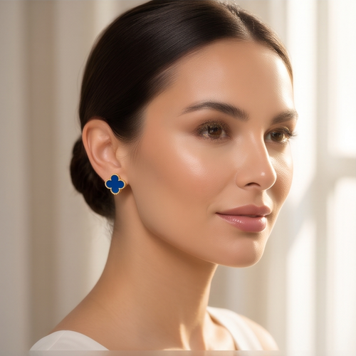 Blue clover stud earrings in a beige velvet jewellery box
