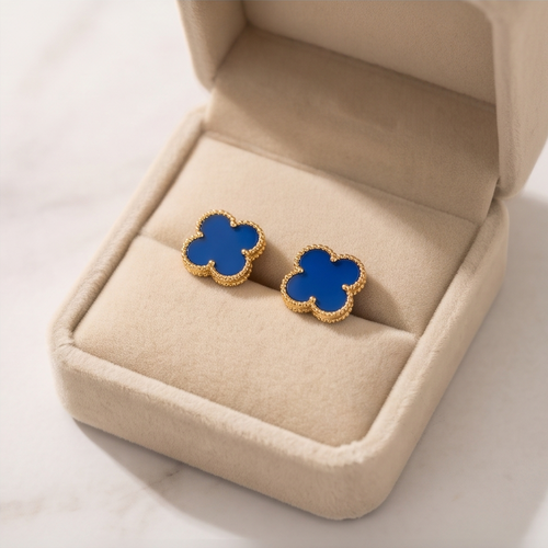 Close-up of blue clover stud earring showing gold beaded milgrain border