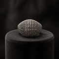 Gunmetal dome pavé ring in black jewellery box on marble surface