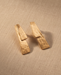 Gold Hammered Double Bar Drop Earrings - product flat lay on linen