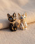 Egyptian Bastet Cat Stud Earrings — black and silver pair on linen flat lay