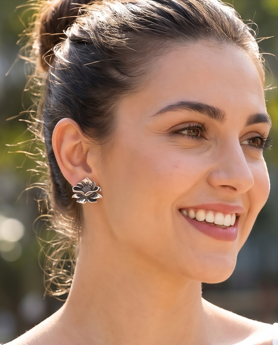 Model wearing oxidised silver lotus flower stud earring
