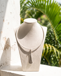 Close-up detail of silver hammered texture on elongated teardrop pendant