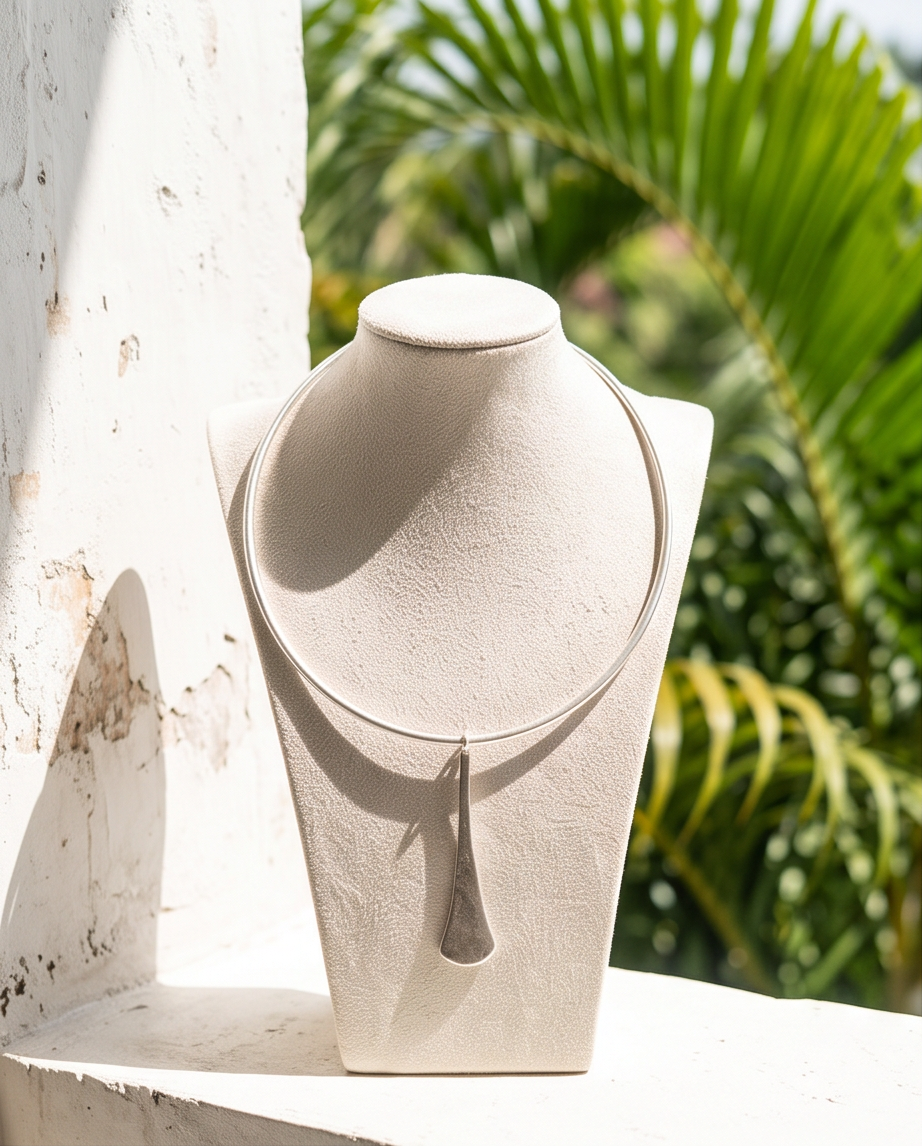Close-up detail of silver hammered texture on elongated teardrop pendant