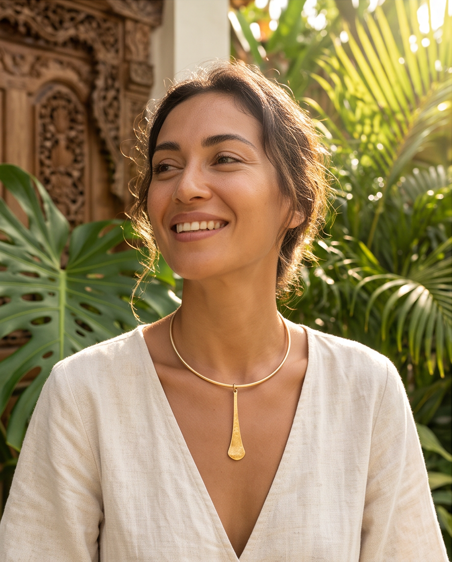 Gold Hammered Elongated Pendant Collar Necklace - close-up detail with sunlight and palm leaf