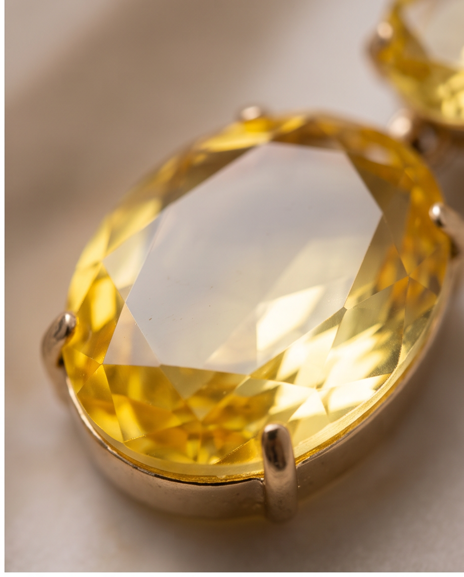 Close-up macro detail of faceted citrine crystal in gold prong setting