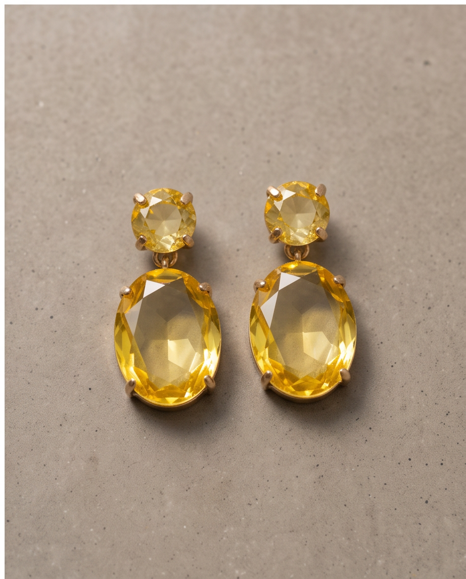Pair of gold citrine crystal double drop earrings on neutral background