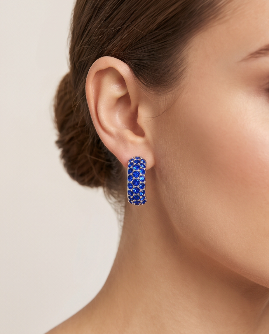 Model wearing silver sapphire crystal pavé hoop earring with elegant updo