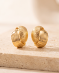 Gold Dual-Texture Chunky Hoop Earrings side by side on stone surface