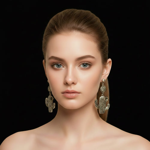 Woman wearing silver cactus-shaped earrings against a gray background