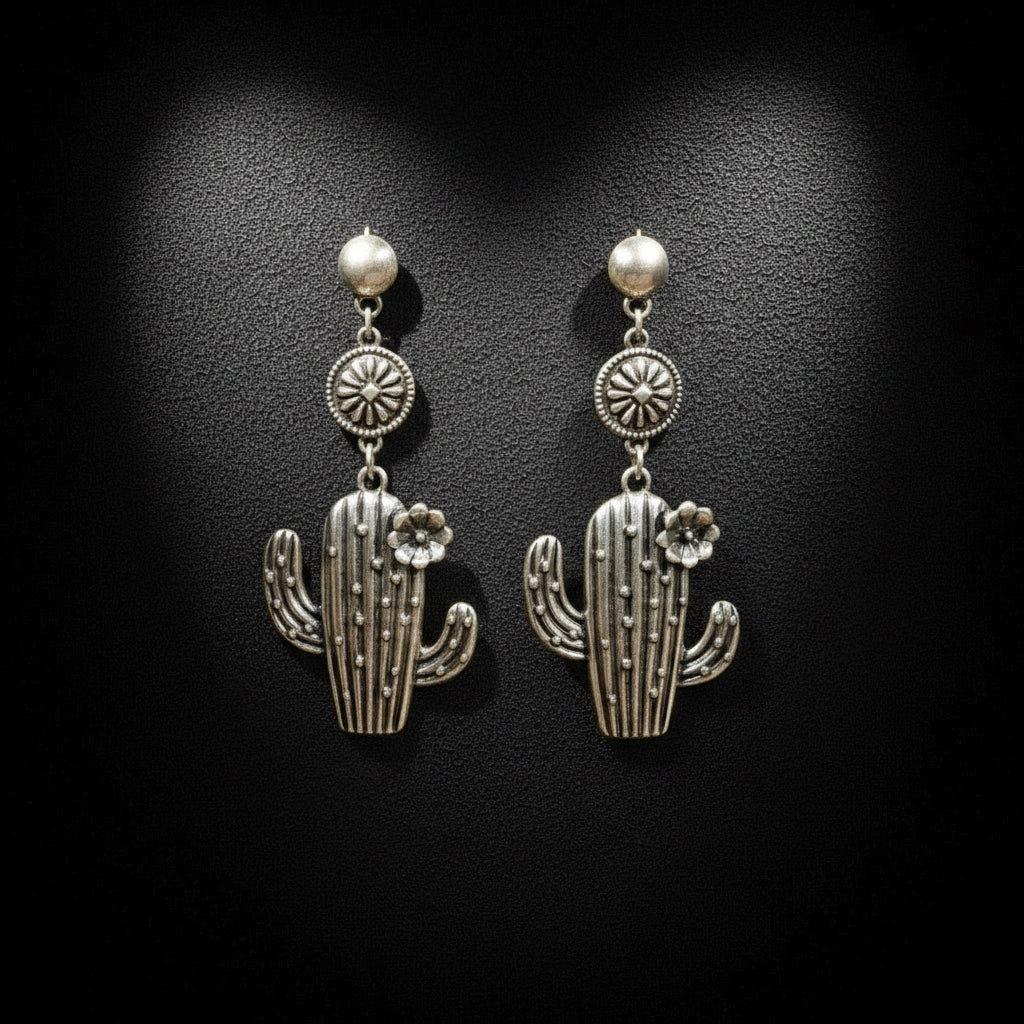 Silver cactus-shaped earrings on a black background