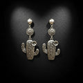Silver cactus-shaped earrings on a black background