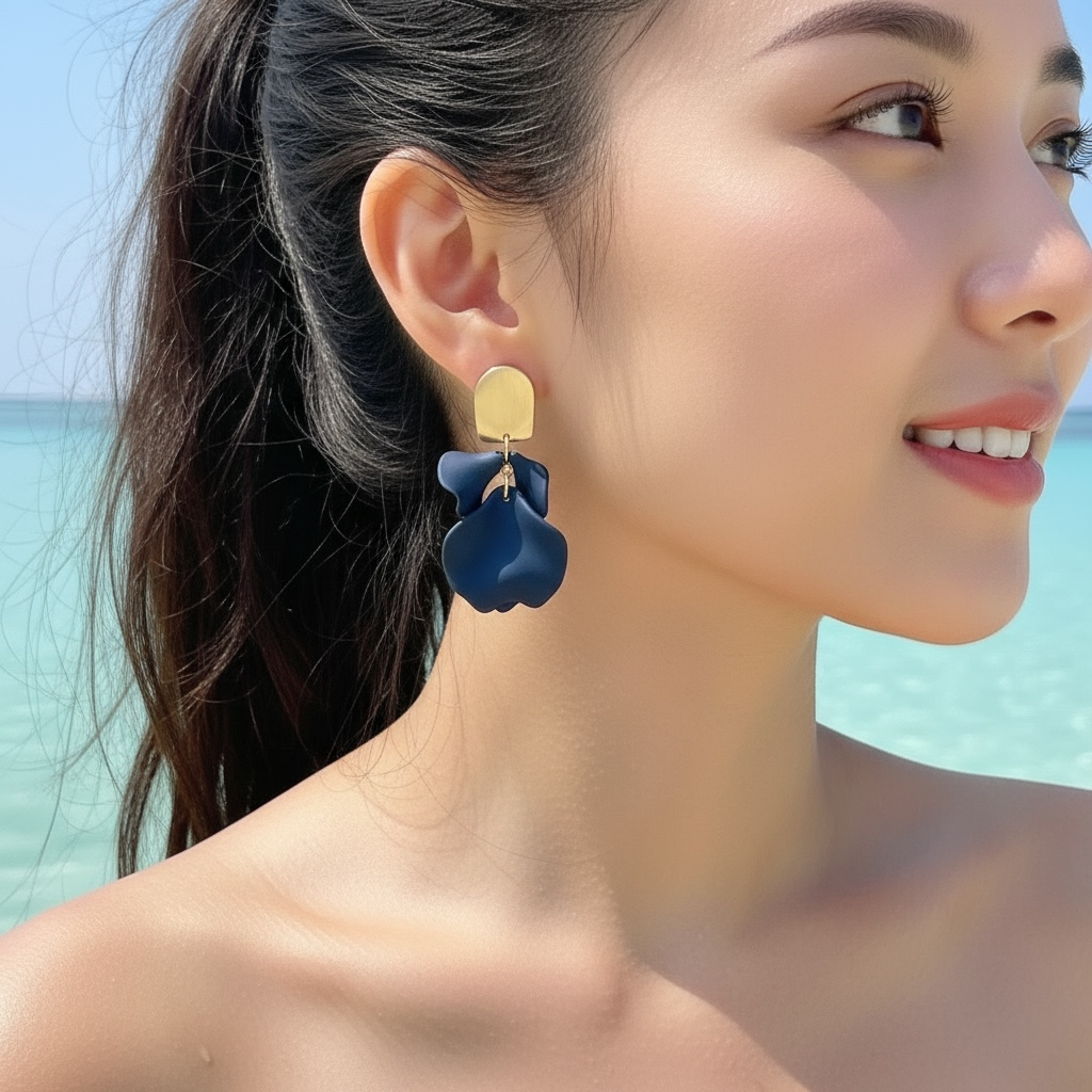 Woman wearing blue floral earrings with a beach background