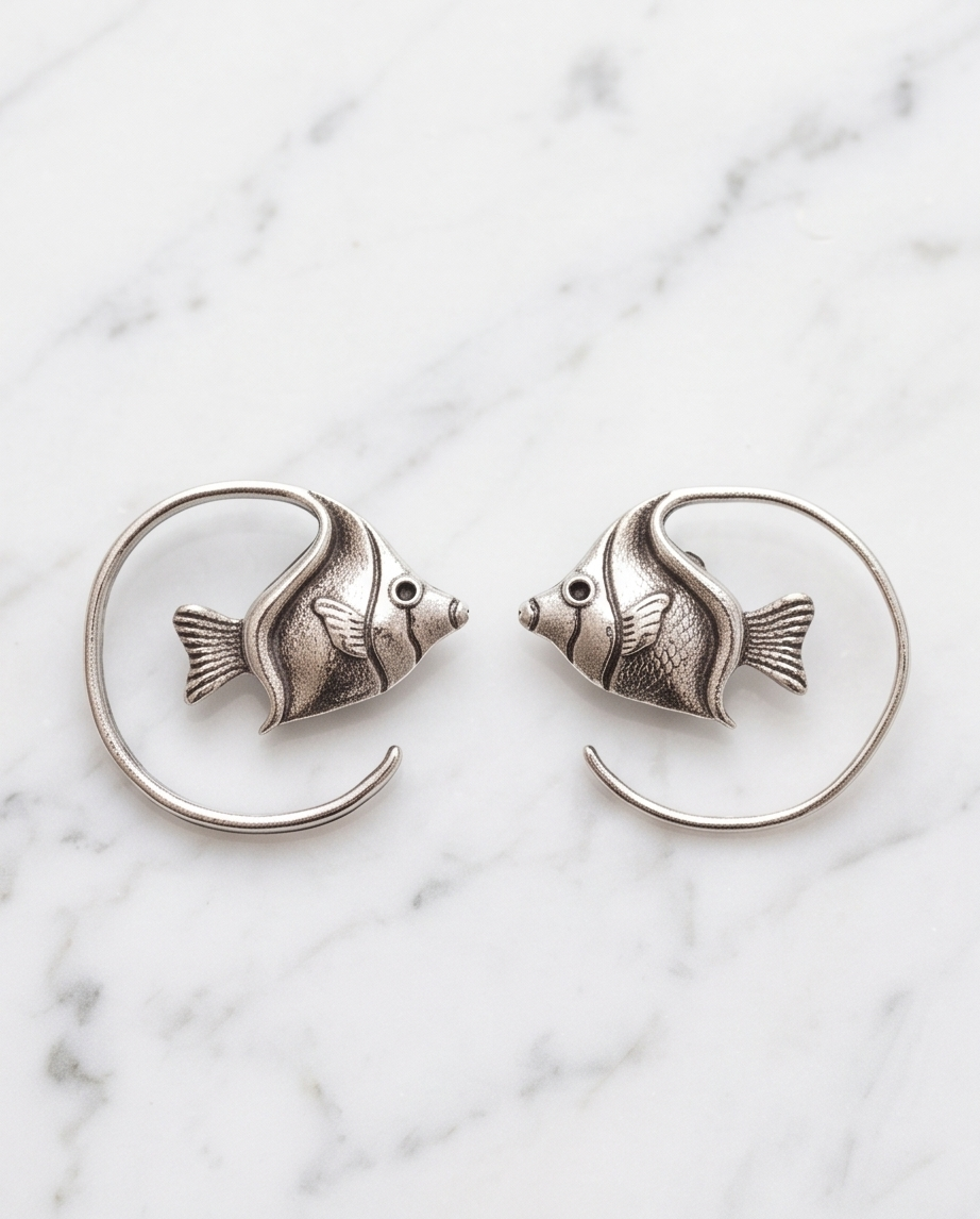 Silver angelfish spiral hoop earrings in kraft gift box with white seashell on white background