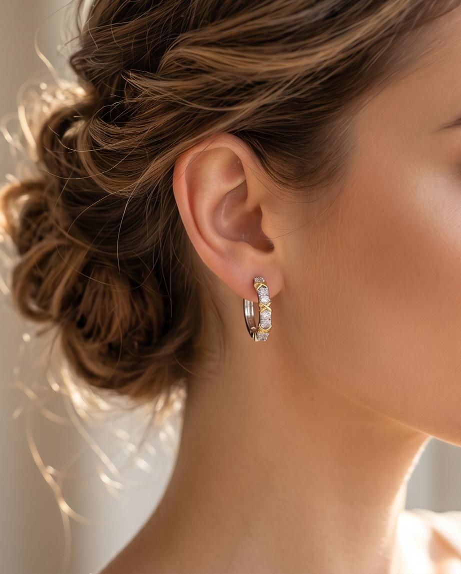 Gold X cross cubic zirconia hoop earring worn on model